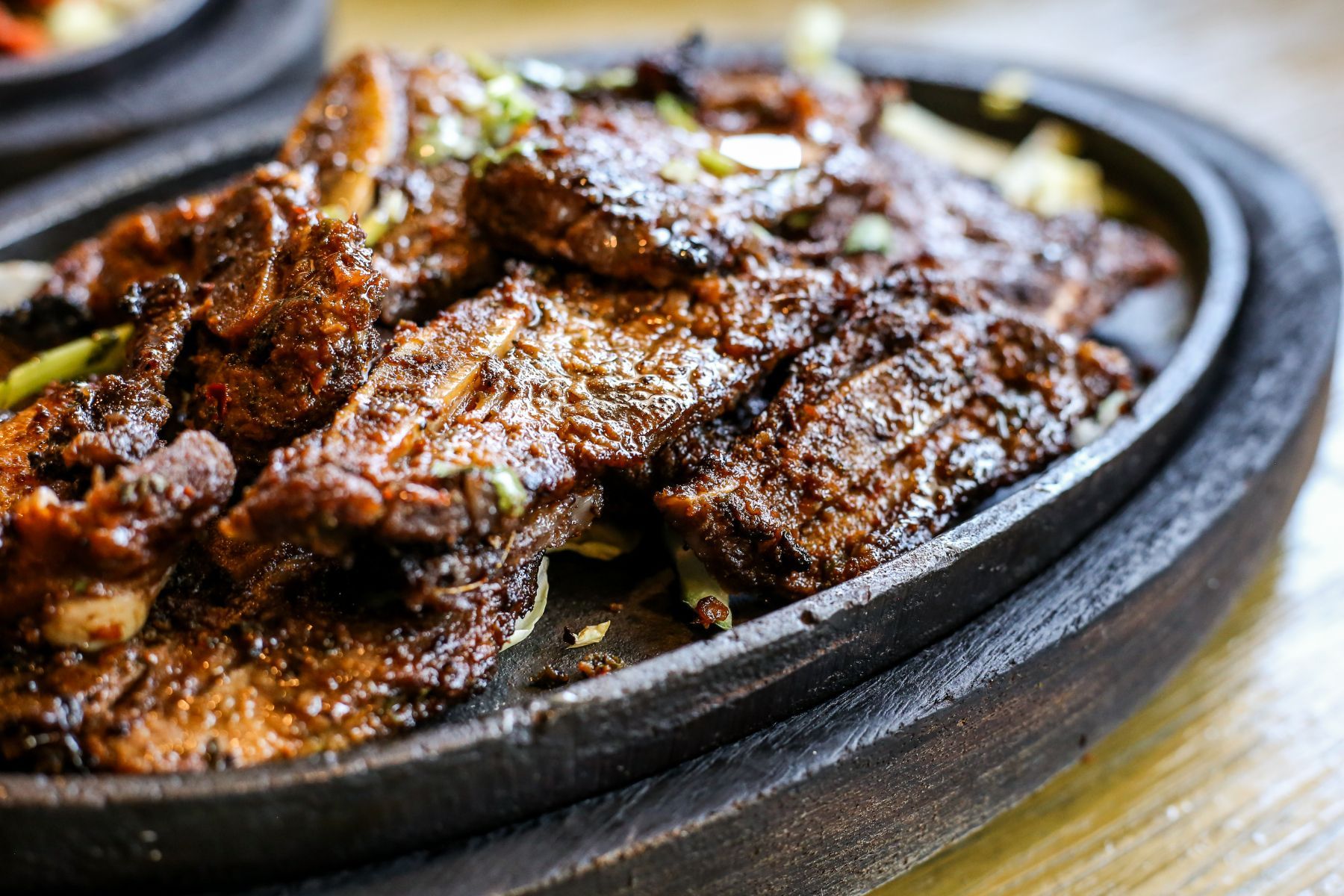 A close up of a plate of food on a wooden table.