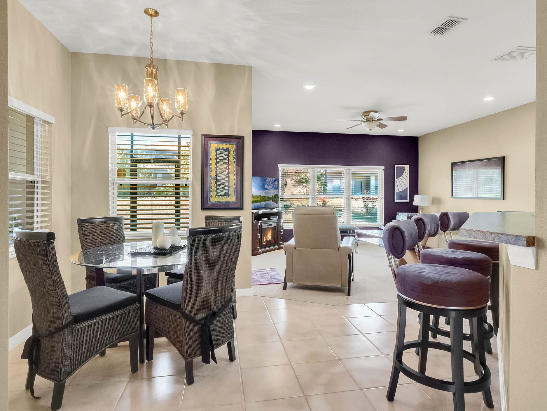 A living room with a table and chairs and a chandelier.