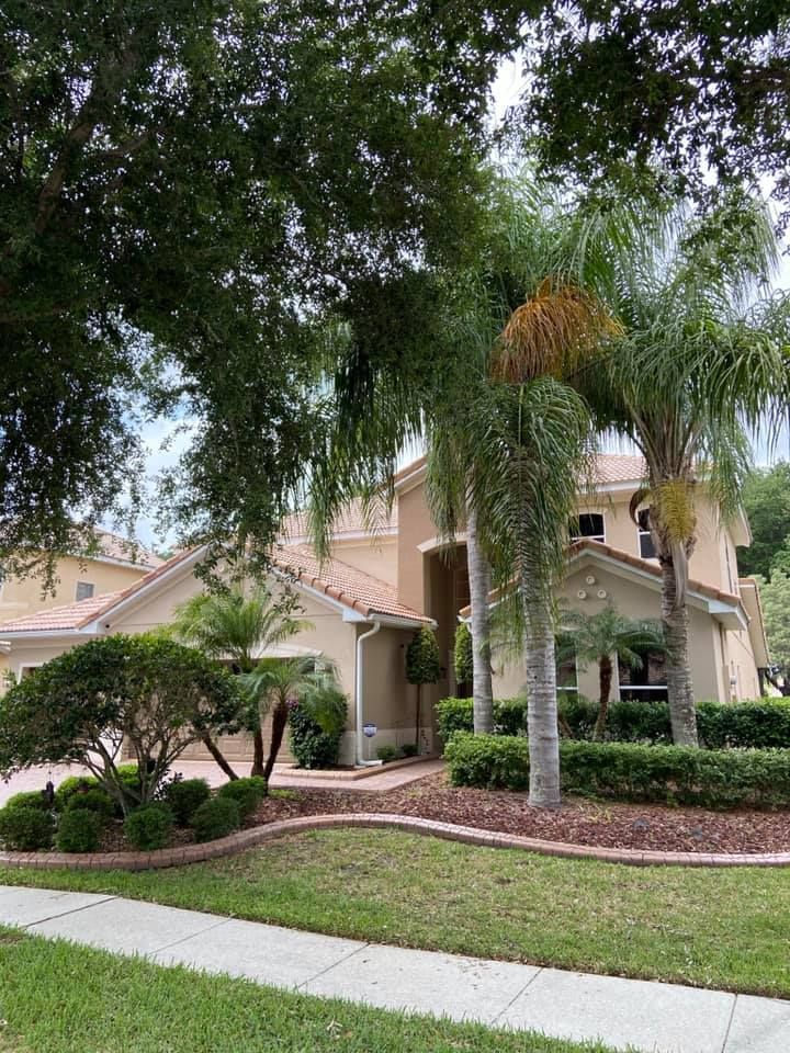 A large house with a lot of trees in front of it.