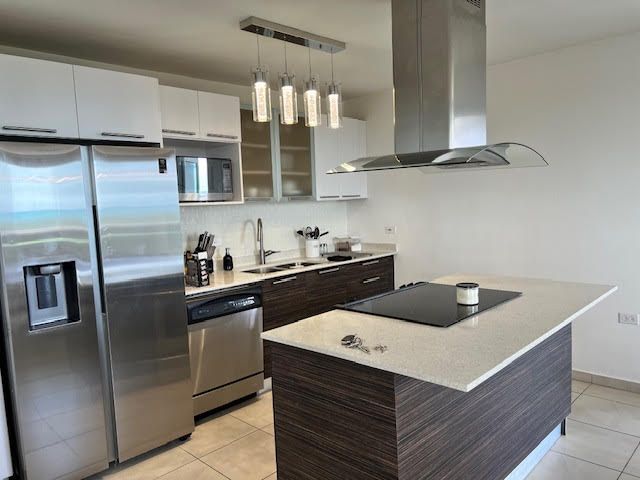 A kitchen with stainless steel appliances and a large island