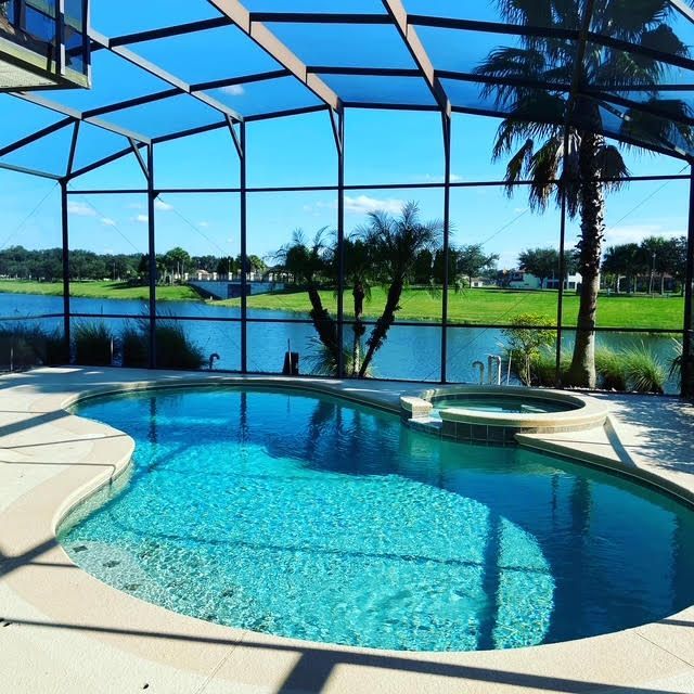 A large swimming pool with a view of a lake