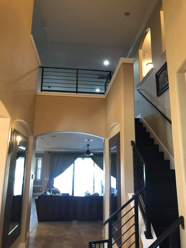 A hallway with stairs leading up to the second floor