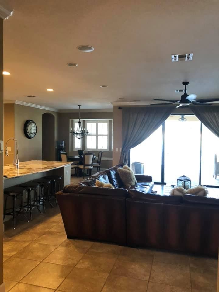 A living room with a couch and a ceiling fan