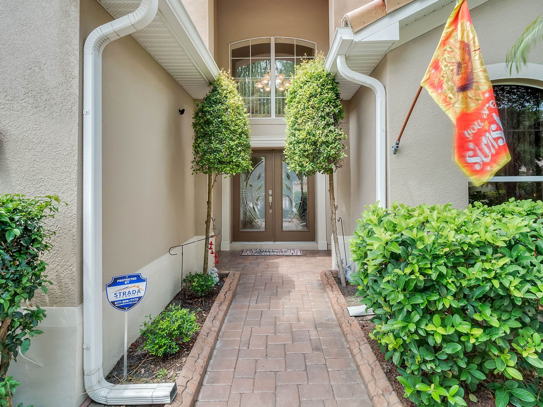 A brick walkway leading to the front door of a house.