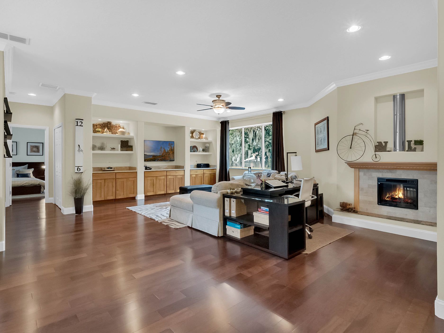 A living room with hardwood floors and a fireplace.