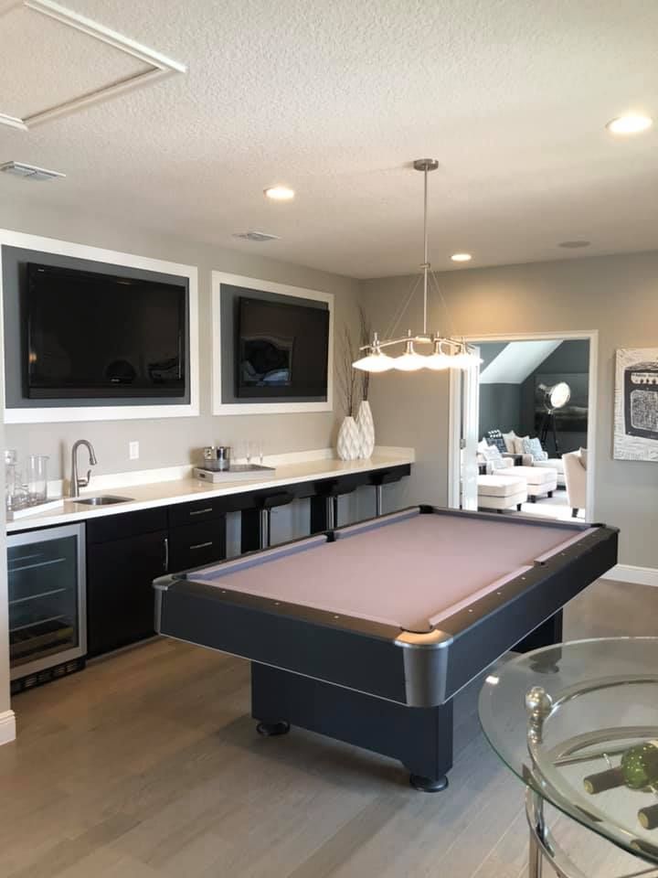 There is a pool table in the middle of the room.
