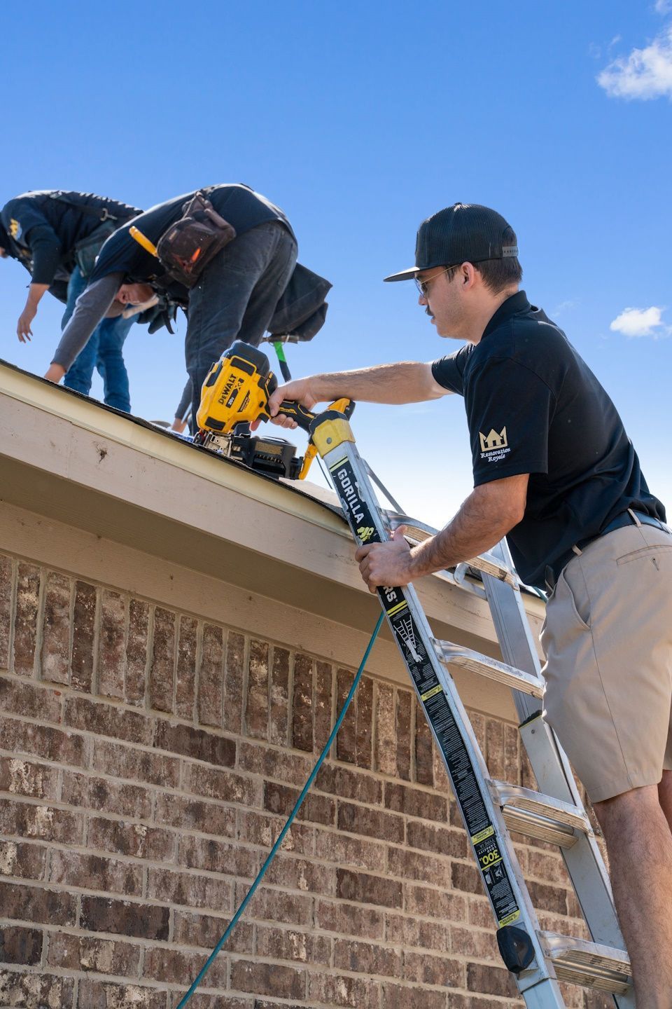 Two men are working on the roof of a building.