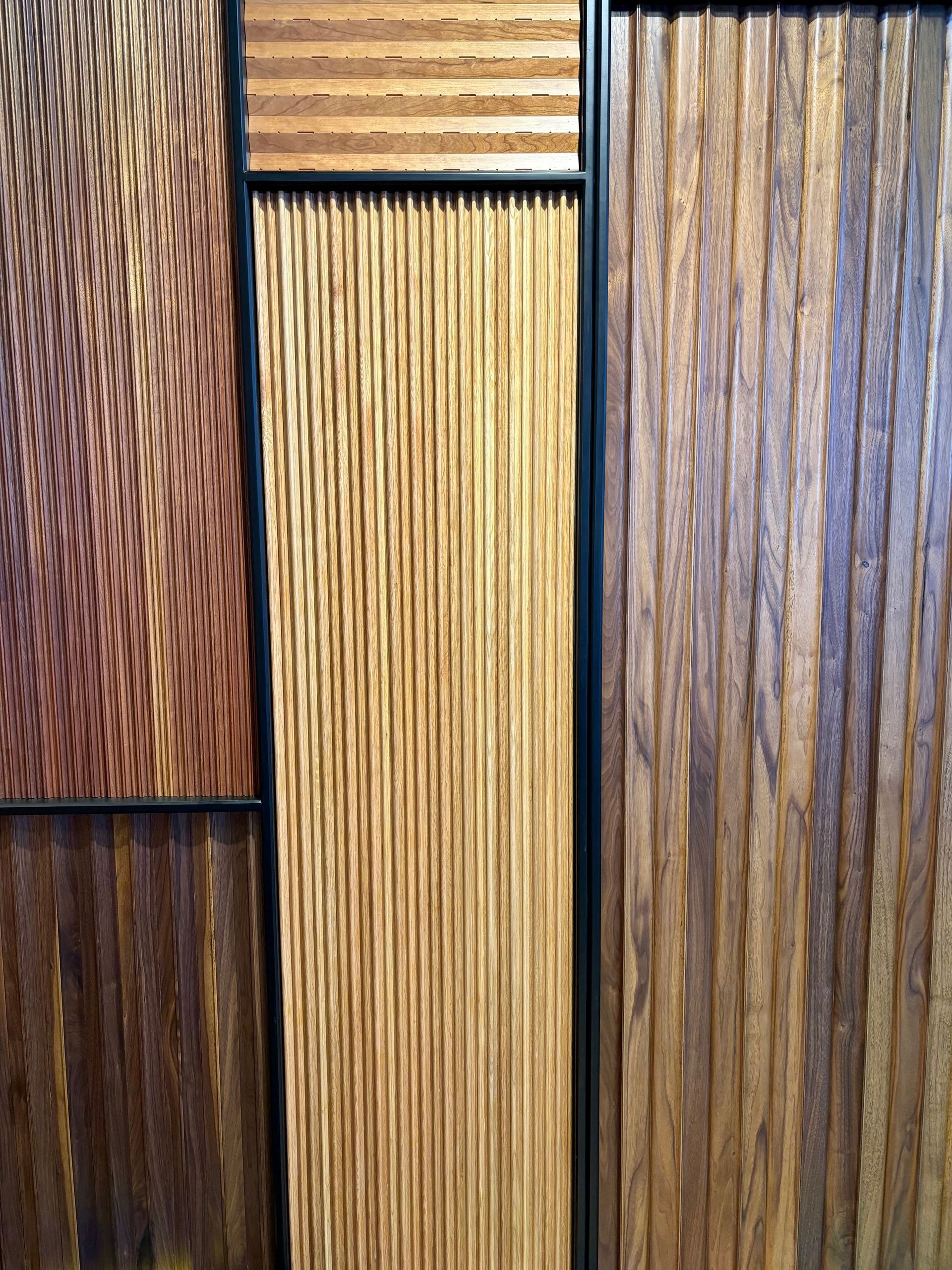 A wooden wall with three different types of wood.