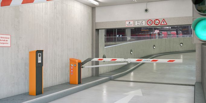 Un estacionamiento con luz verde y una barrera.