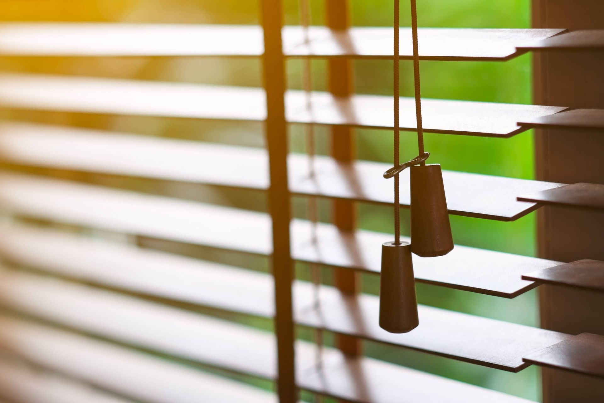 Wood front door blinds blocking light in a home at Hill Country Blinds near Spicewood, TX