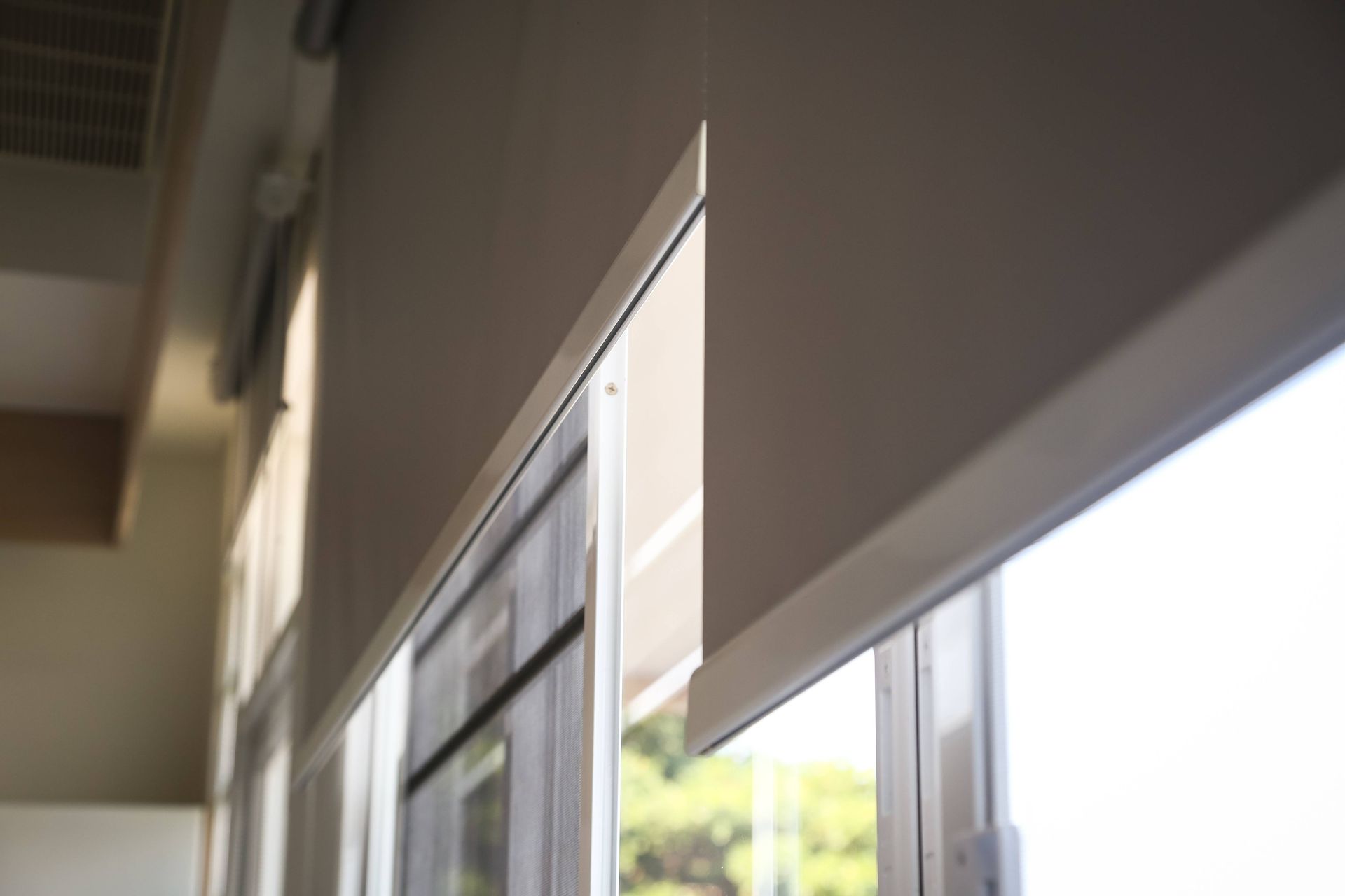 Dual roller shades covering multiple windows in a home near Austin, TX