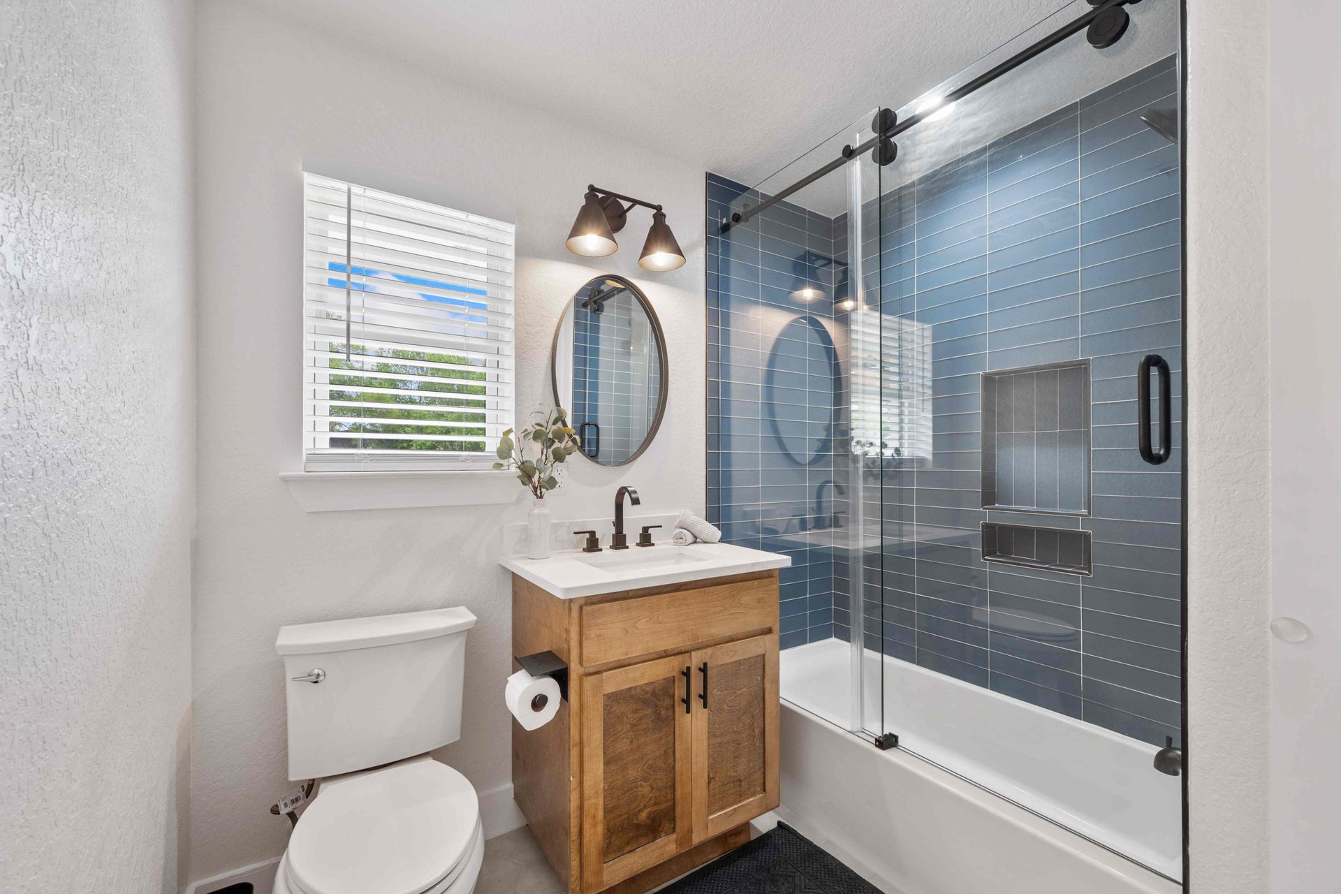 White shutters covering a small bathroom window at Hill Country Blinds near Spicewood, TX