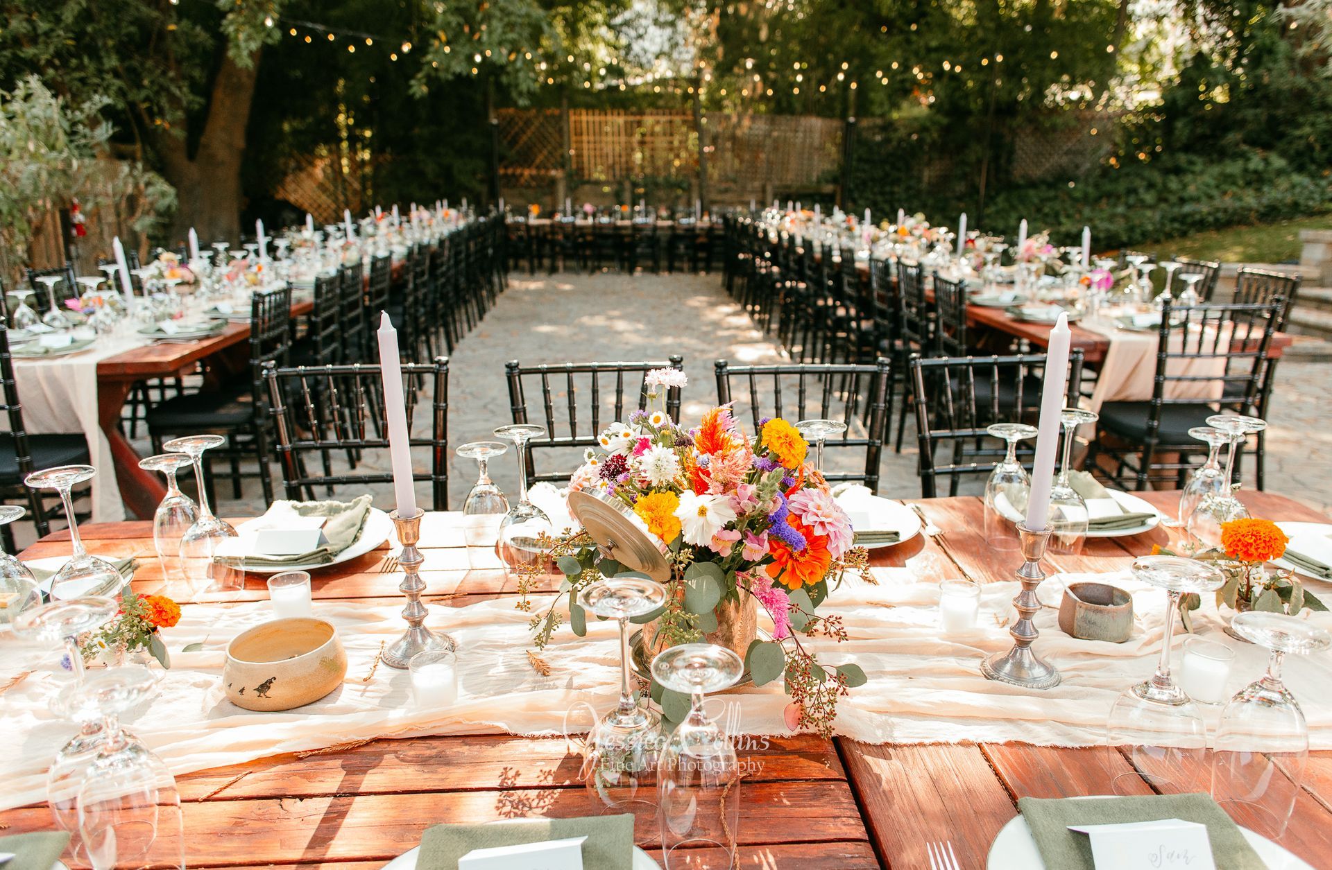 A large wedding reception dinner table out on the terrace
