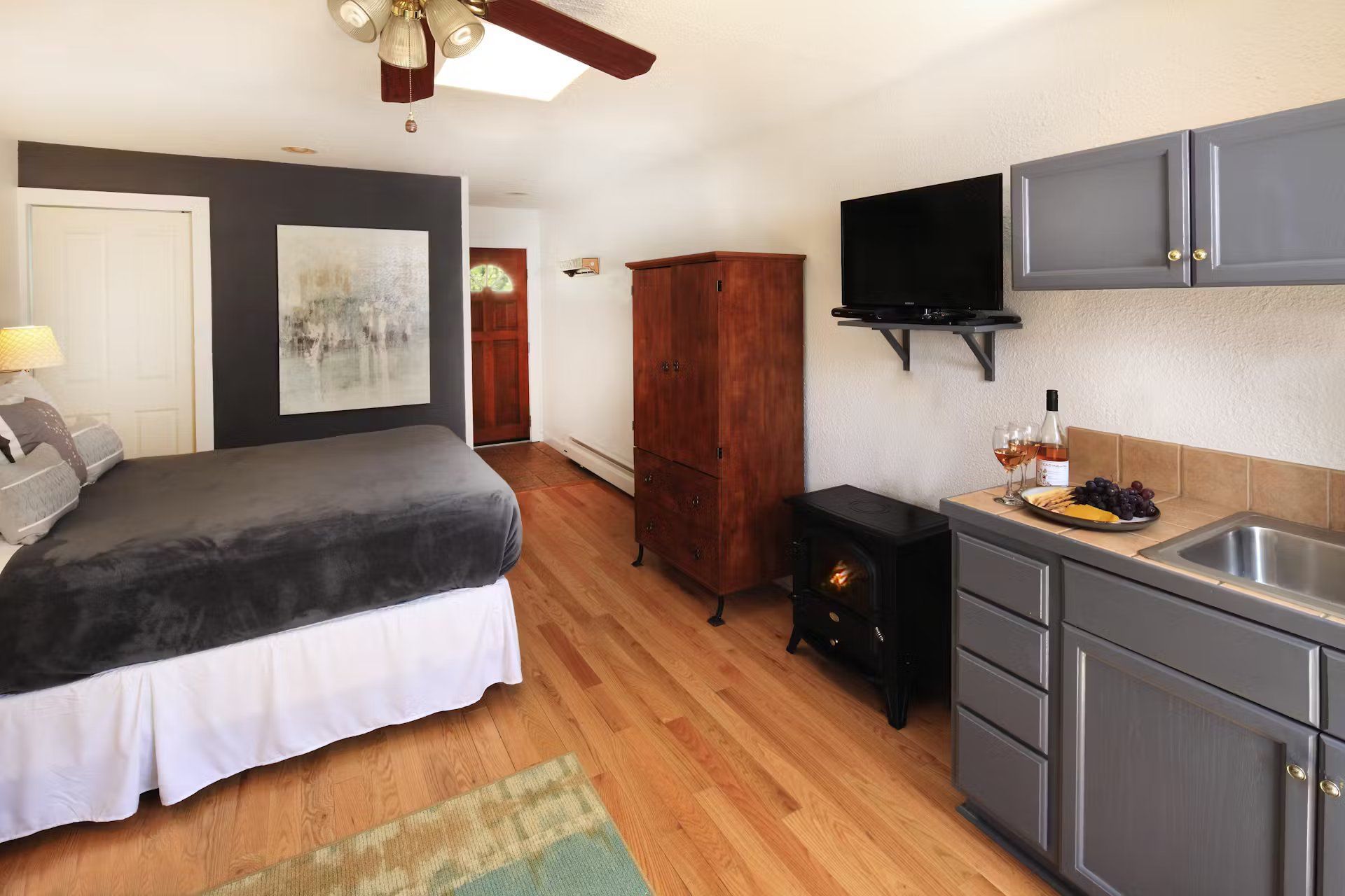 A bedroom with a king size bed and a kitchen