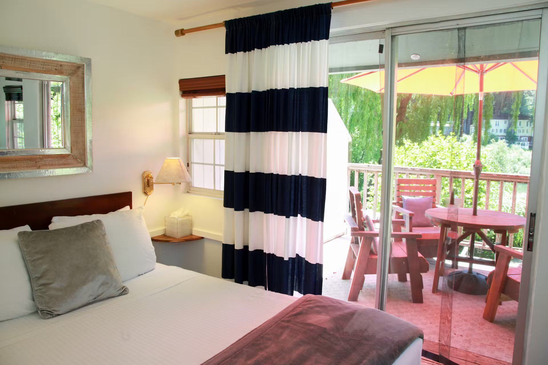 A bedroom with a sliding glass door leading to a balcony