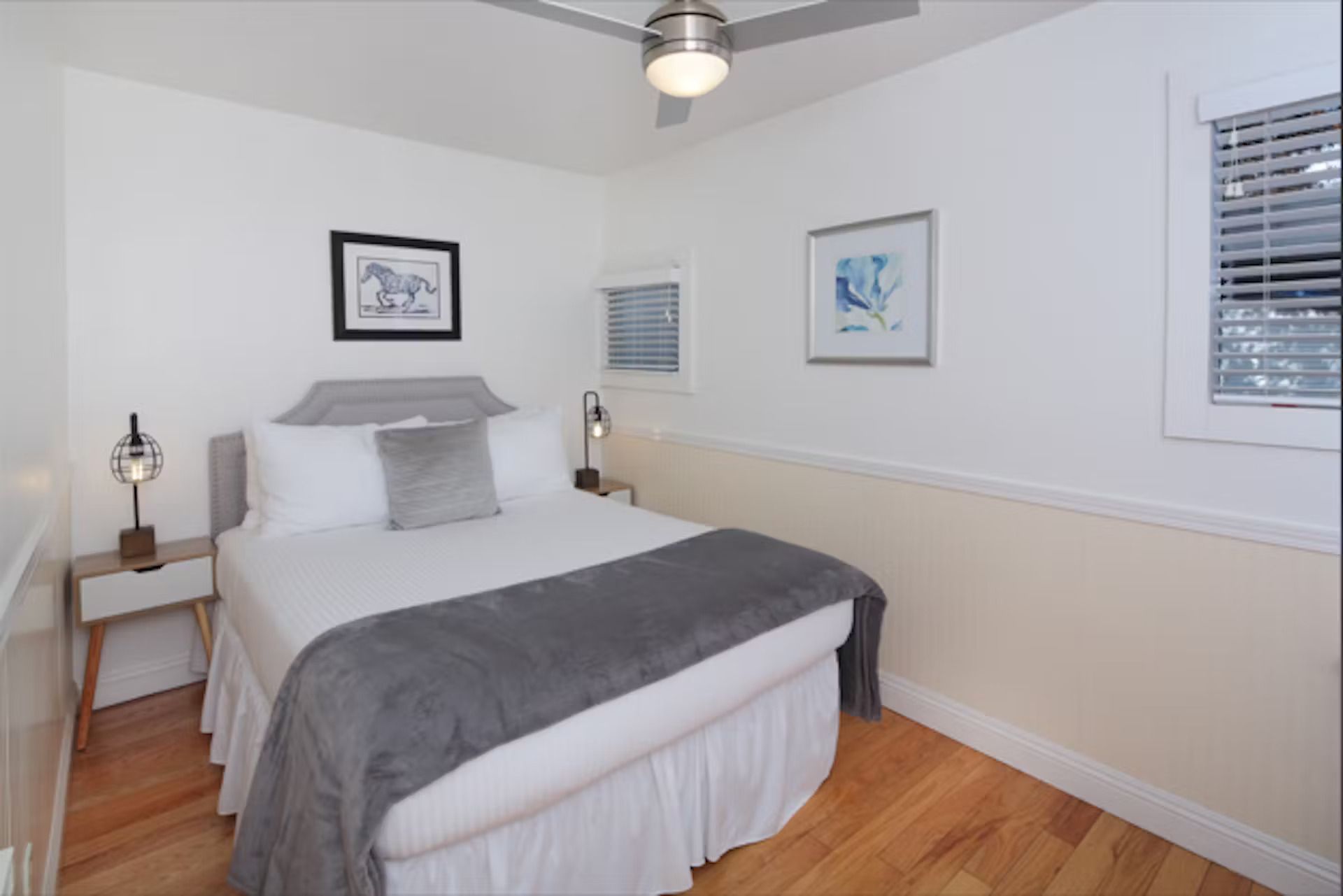 A bedroom with a bed and a ceiling fan
