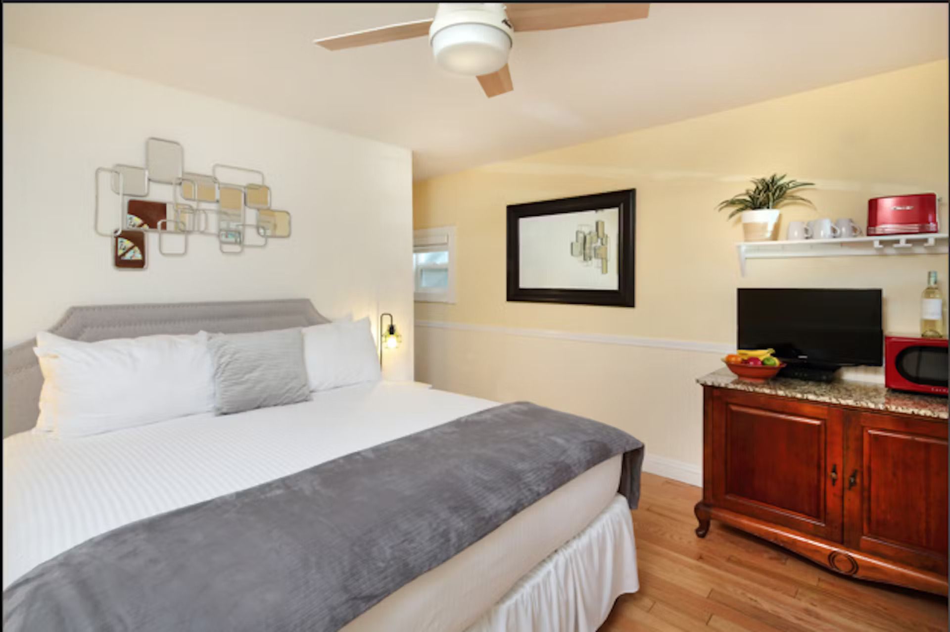 A bedroom with a king size bed and a television