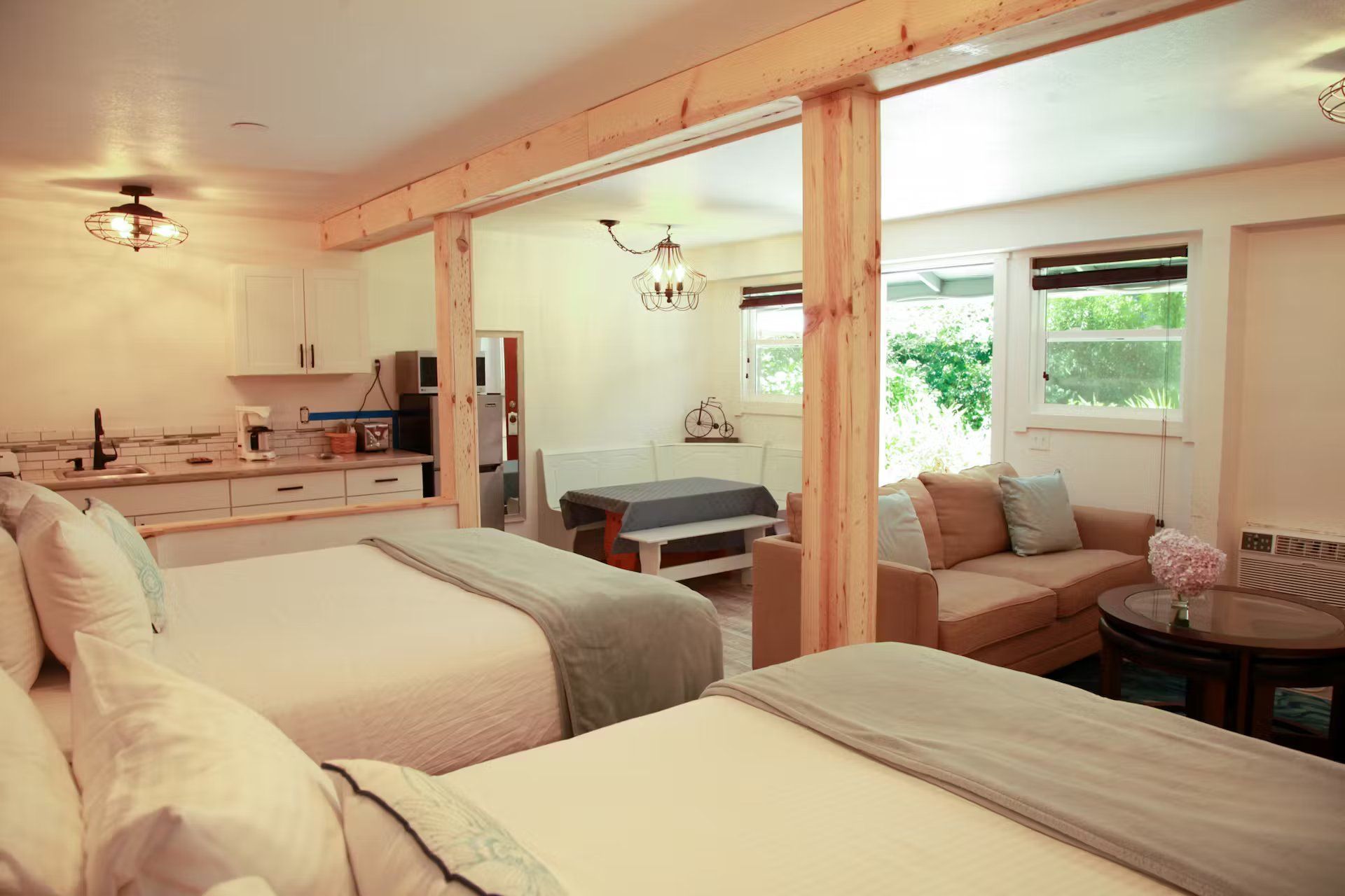 A hotel room with two beds , a couch , and a table.