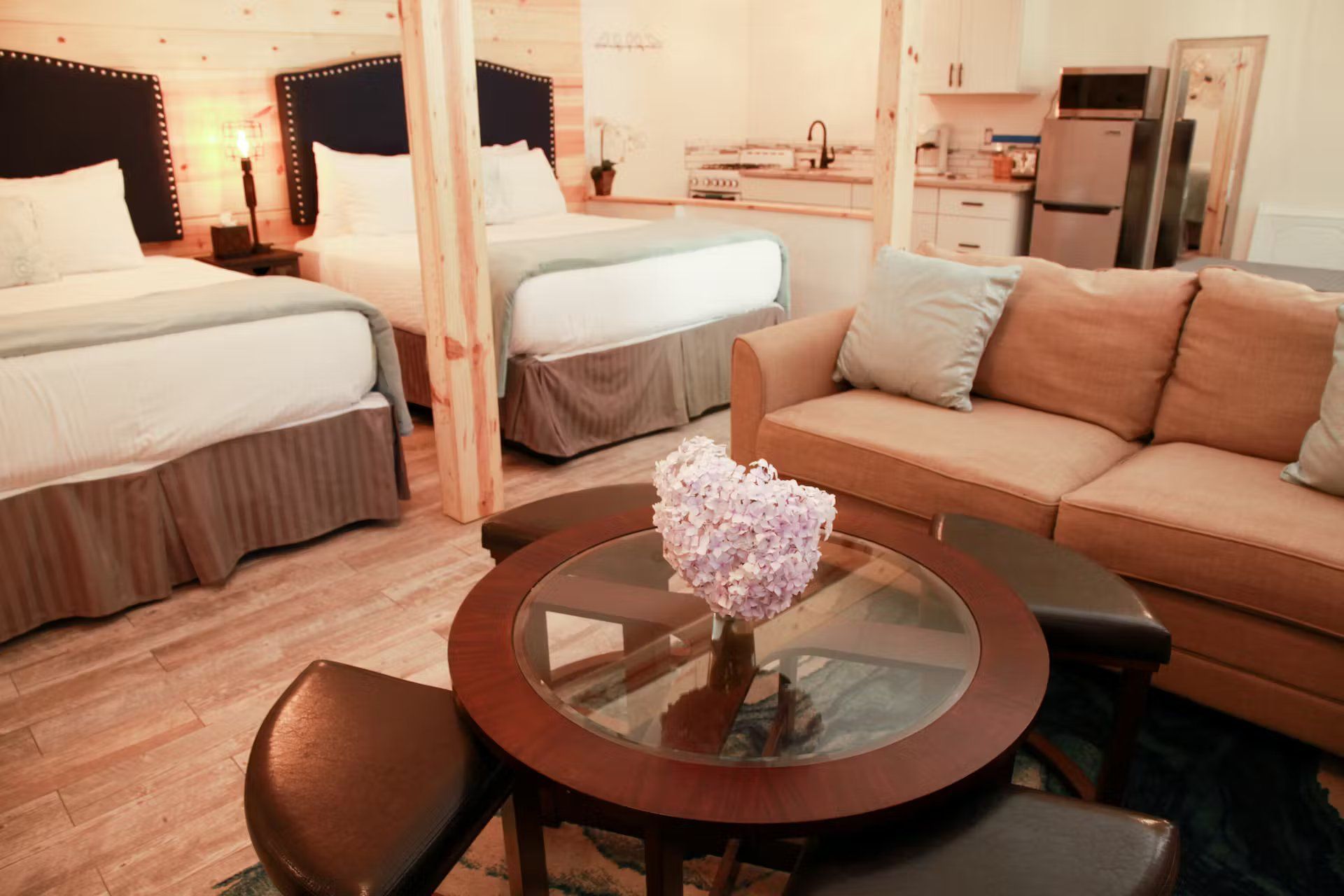 A hotel room with two beds , a couch , and a table.