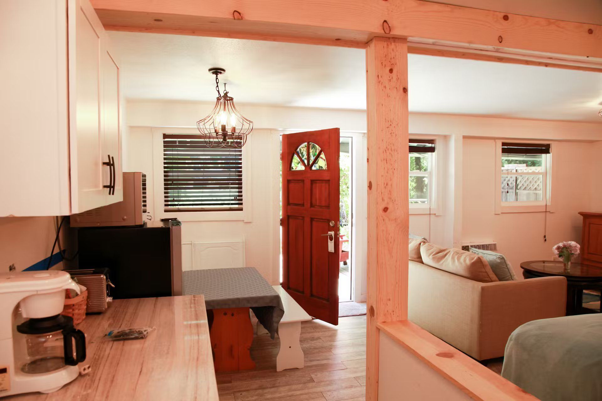 A living room with a red door and a table