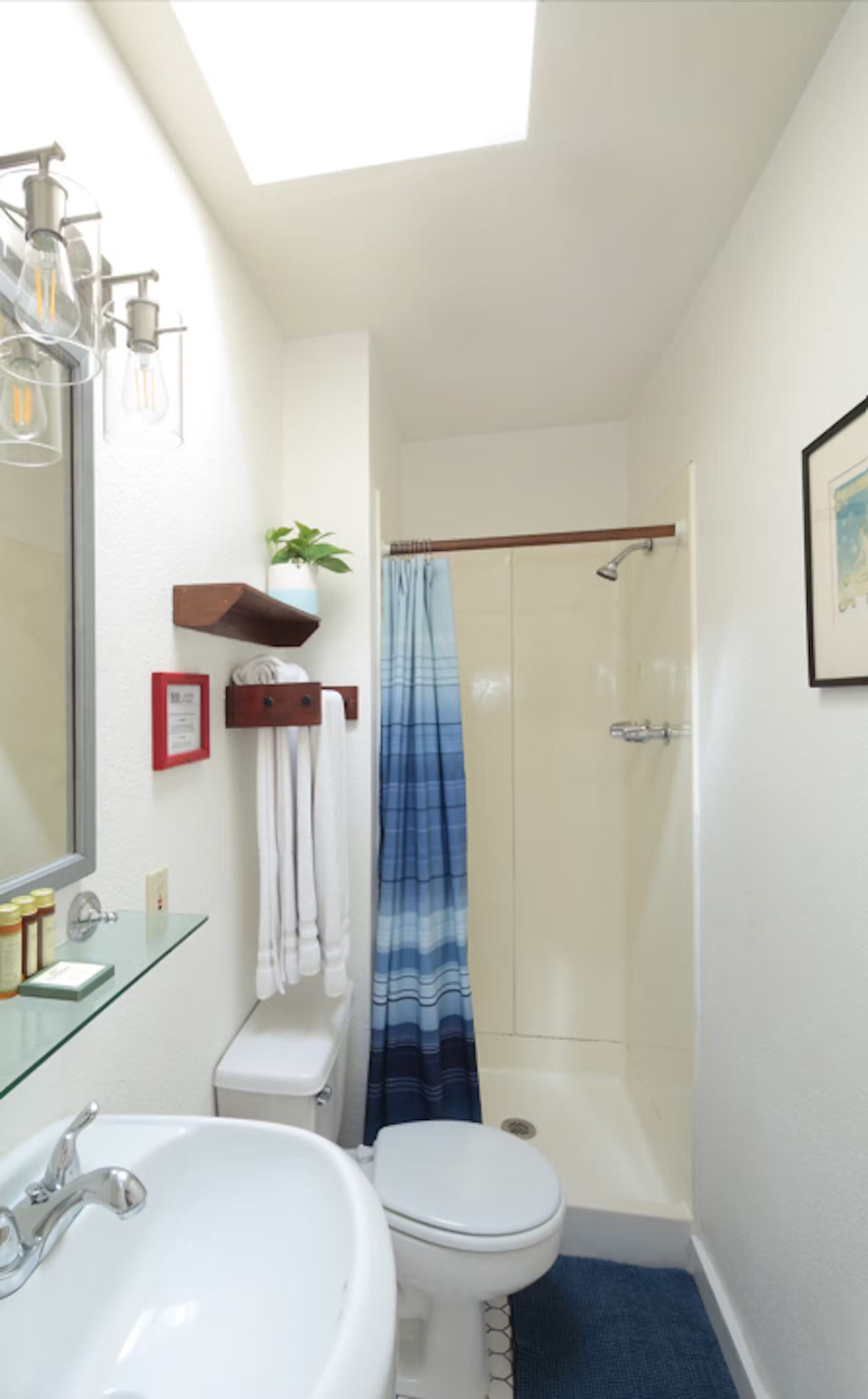 A bathroom with a toilet a sink and a shower