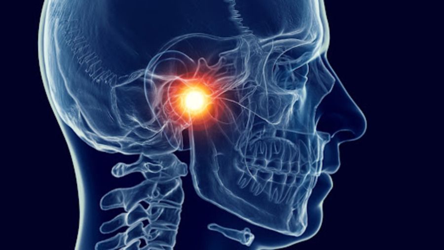 X-ray of a head, showing a highlighted, painful area in the temporomandibular joint (TMJ).