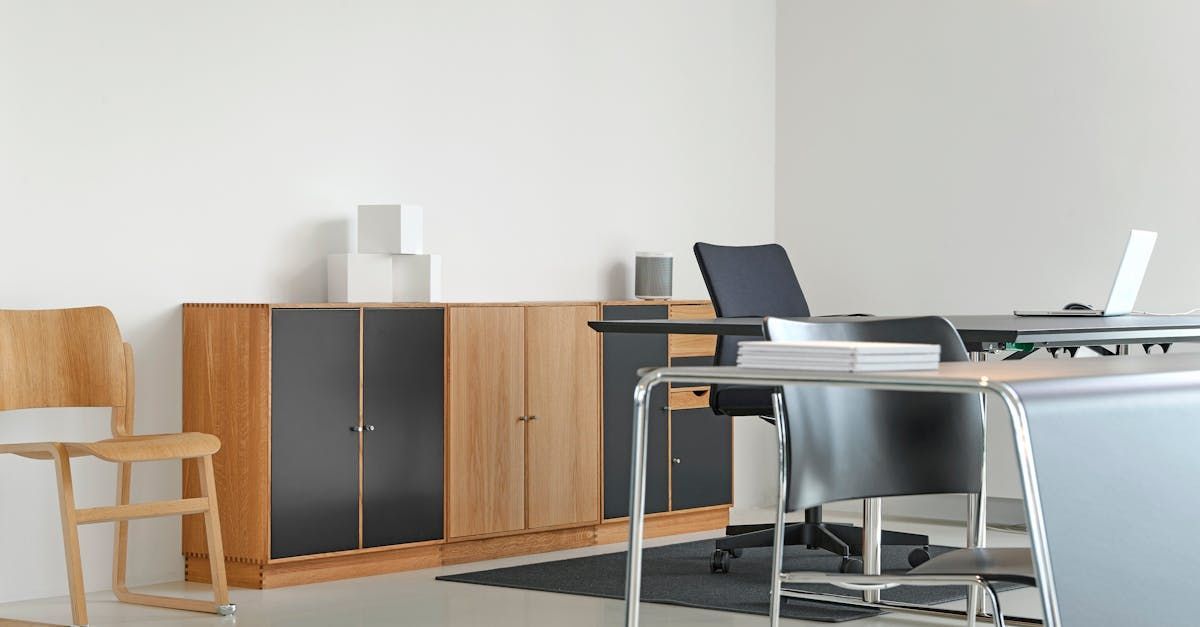 Beautiful cabinetry with chairs and desks in an office space.