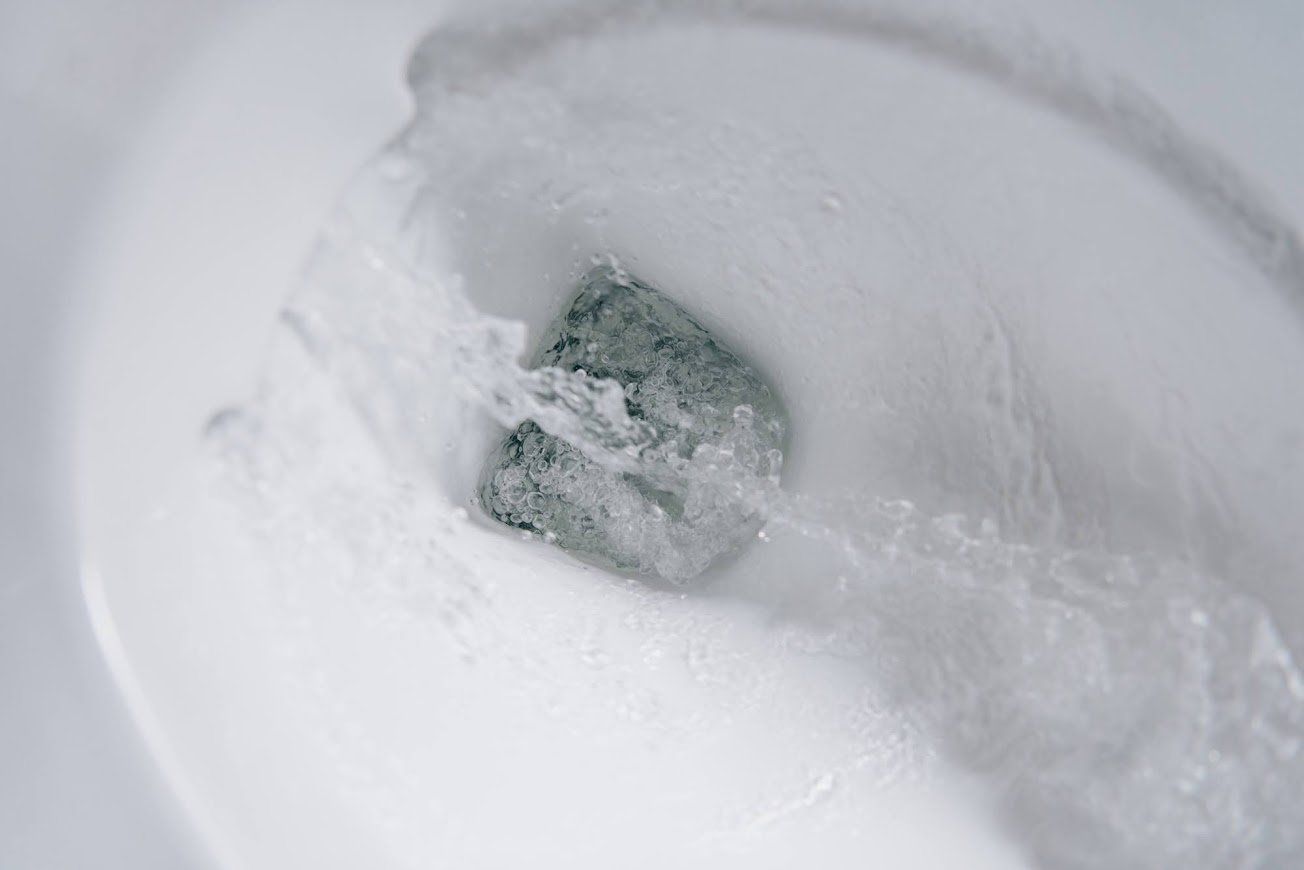 Toilet flushing with clean water — no visible mineral stains or hard water buildup