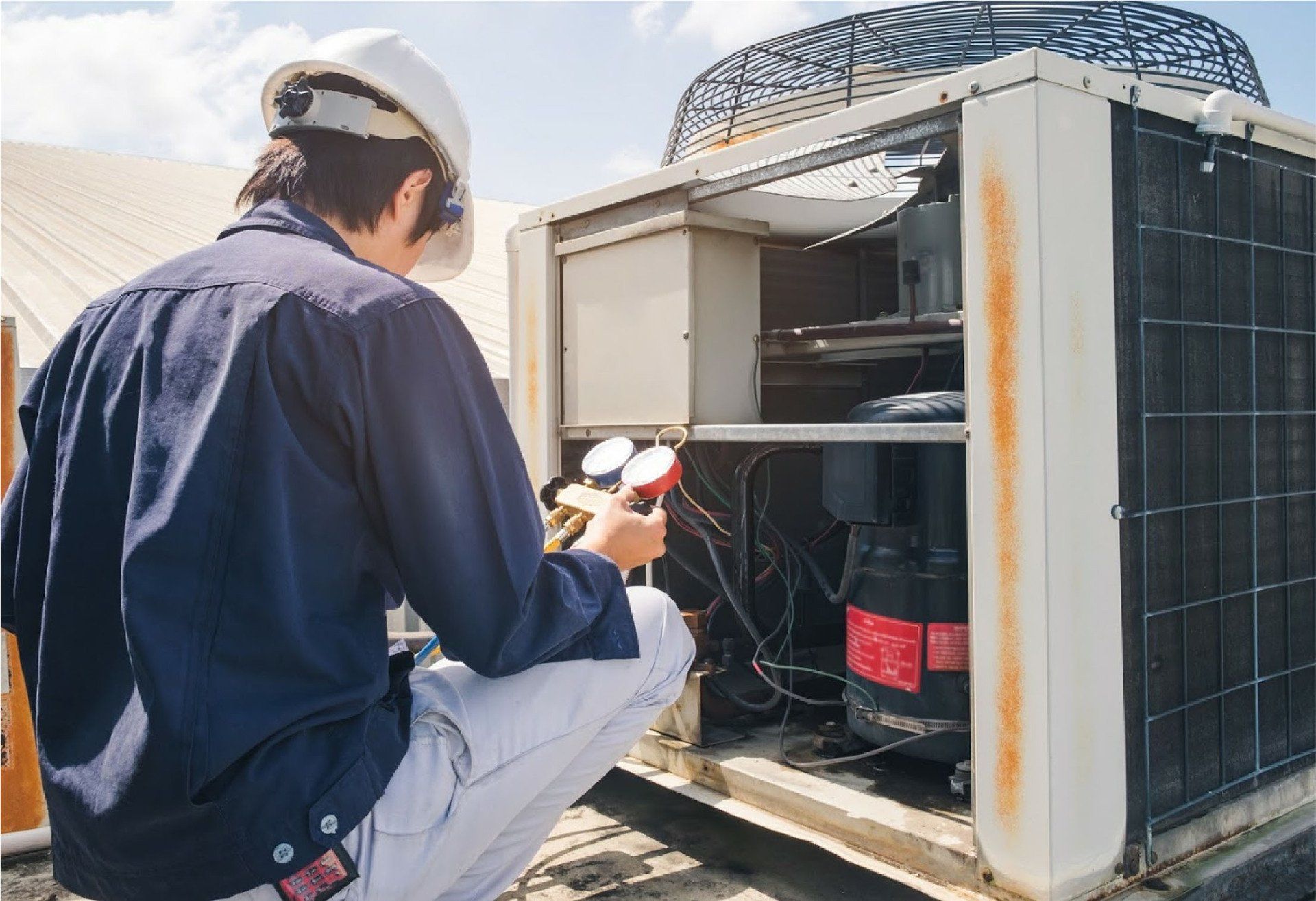 Technician Checking Air Conditioner — Fresno, CA — Art Douglas Plumbing Inc. Technician Checking Air Conditioner — Fresno, CA — Art Douglas Plumbing Inc.