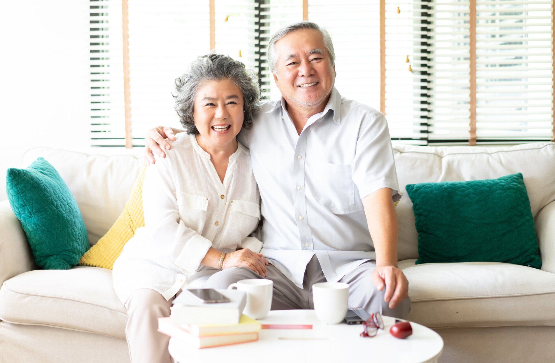 Older couple smiling on couch
