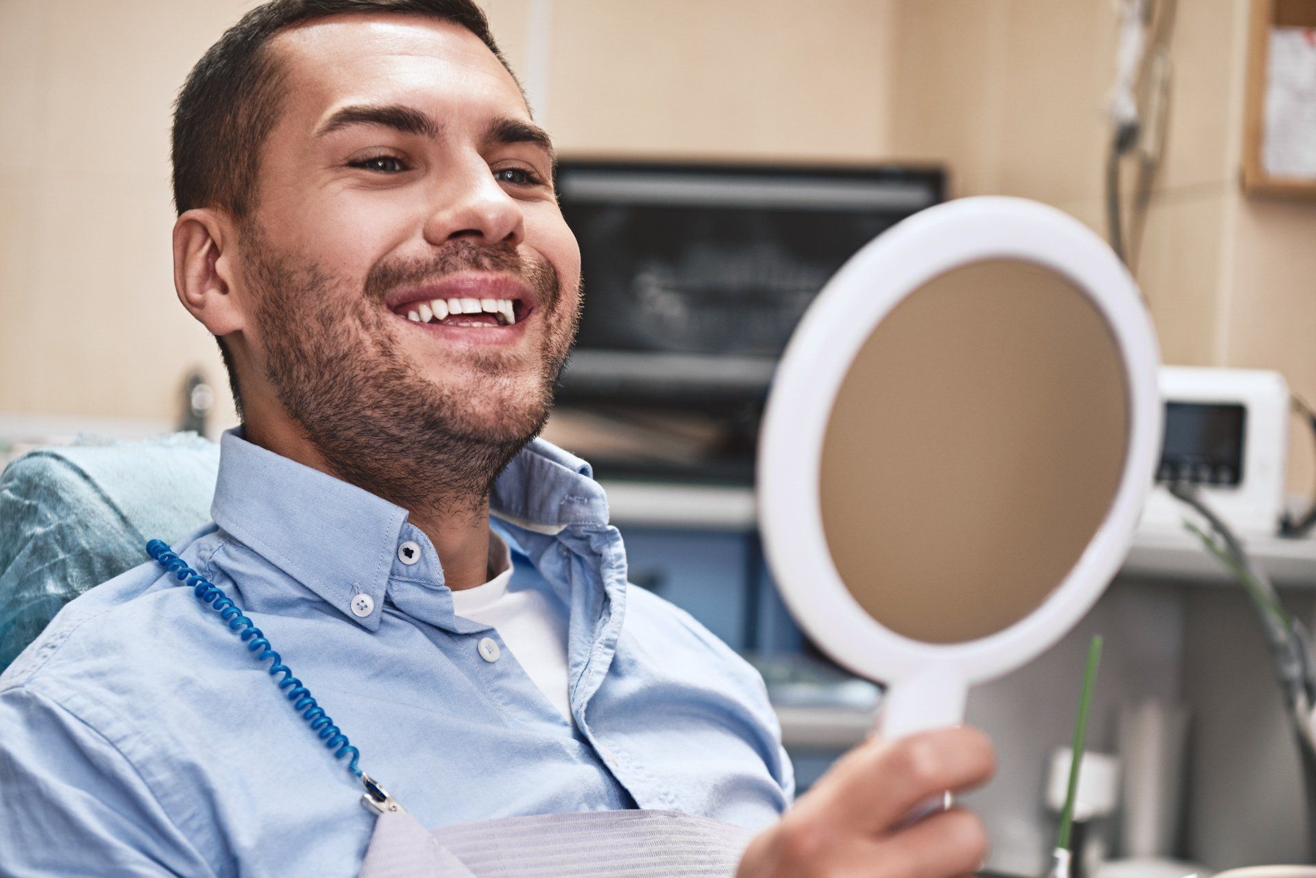 Man in dental chair checking teeth