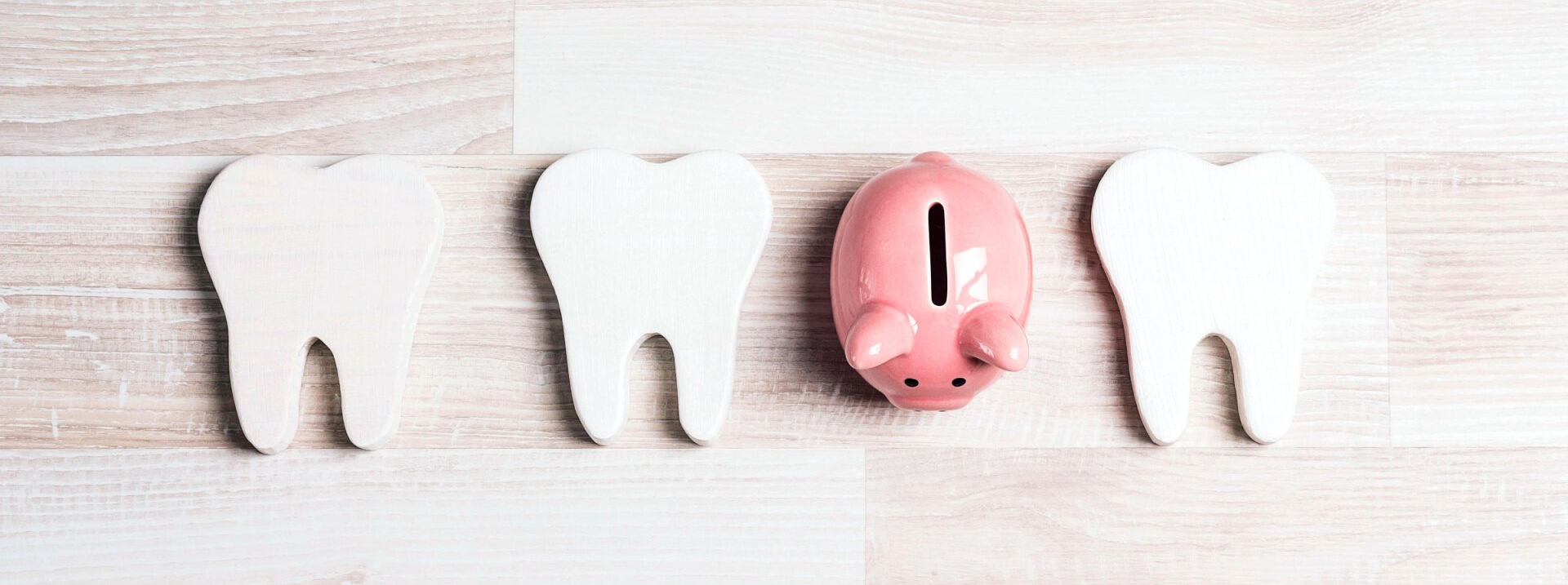 Teeth icons in line with piggy bank in middle
