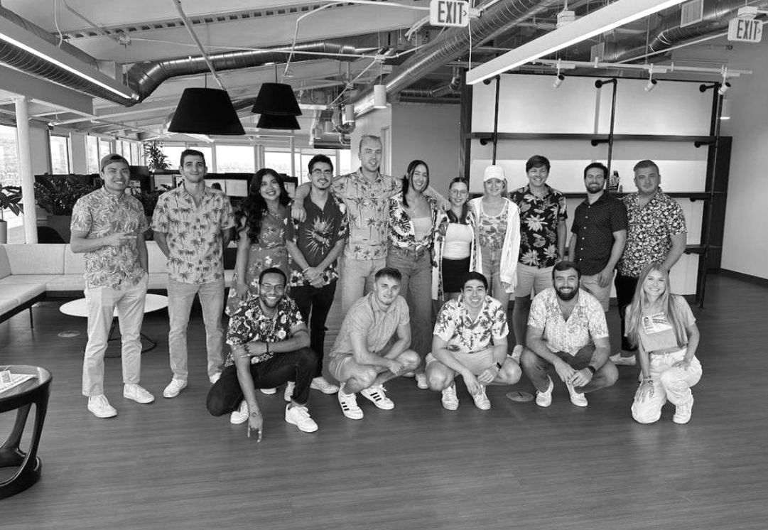 A group of people are posing for a picture in a room.