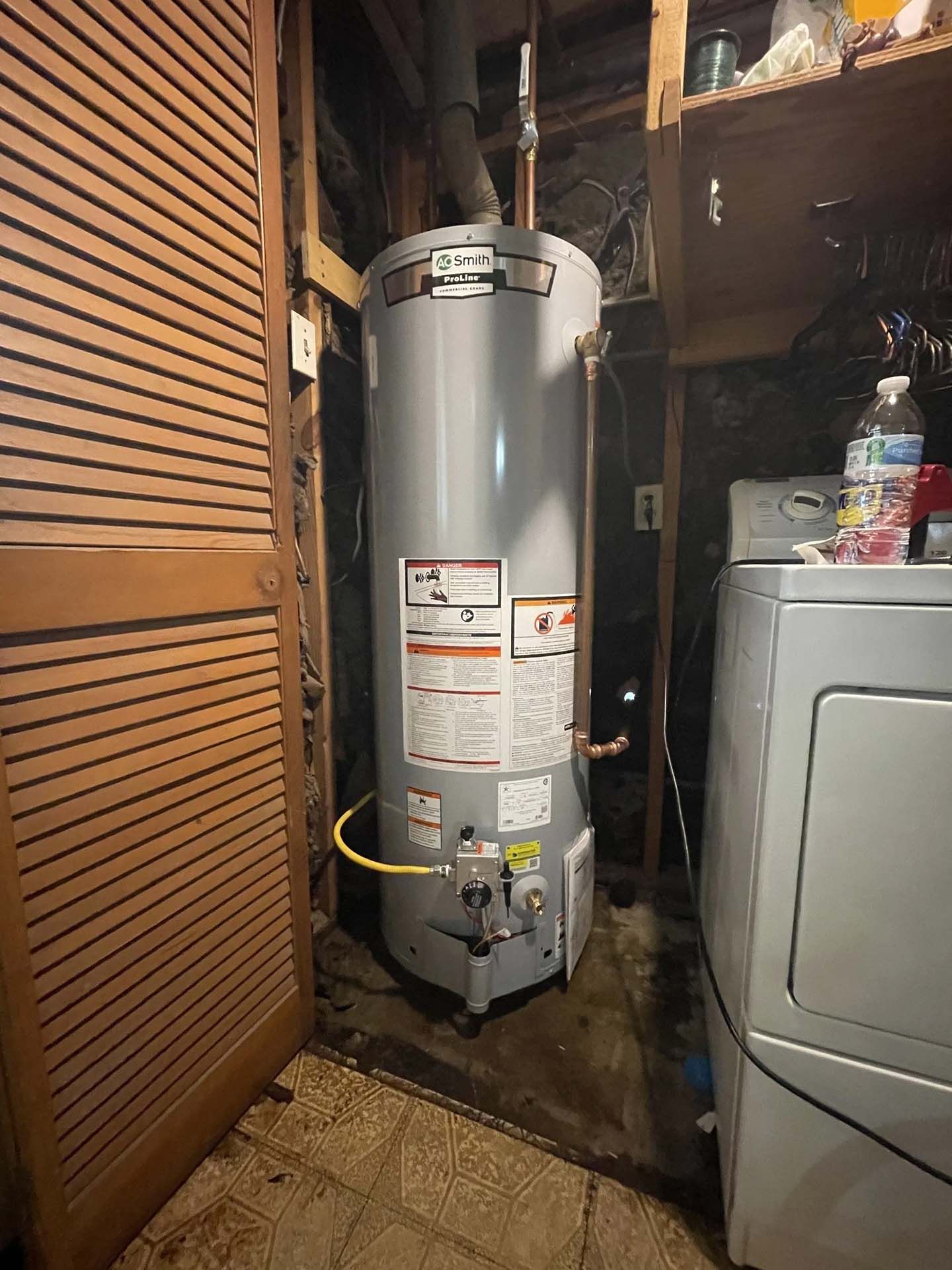 A water heater next to a wooden door