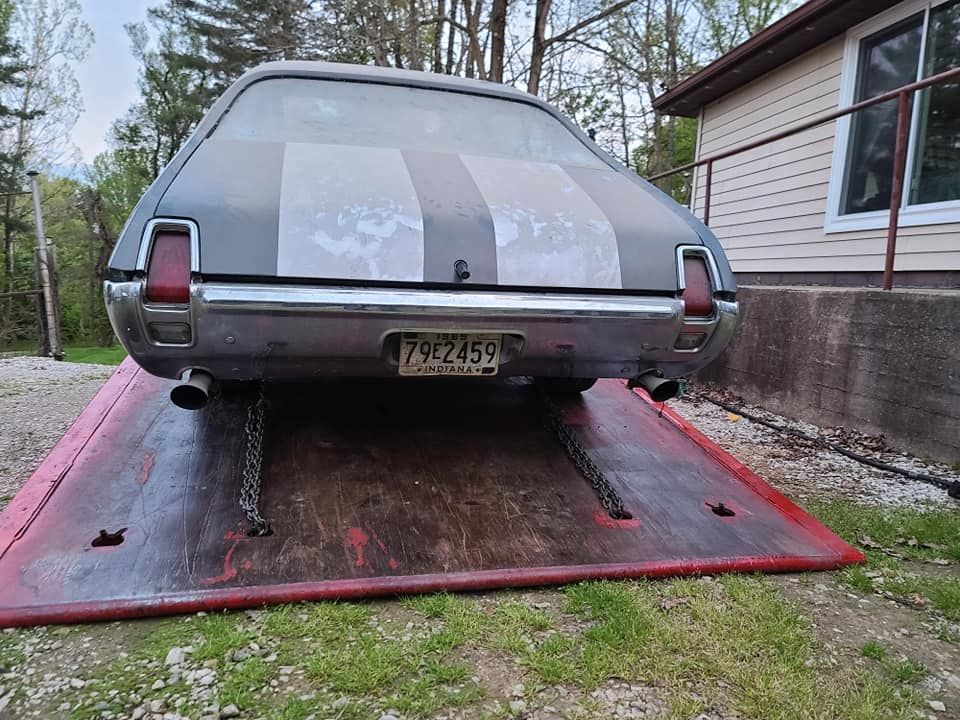 A car is sitting on top of a tow truck.