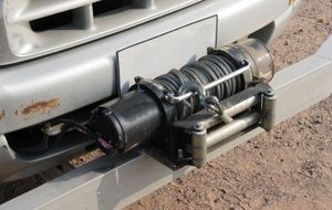 A close up of a winch on the front of a car