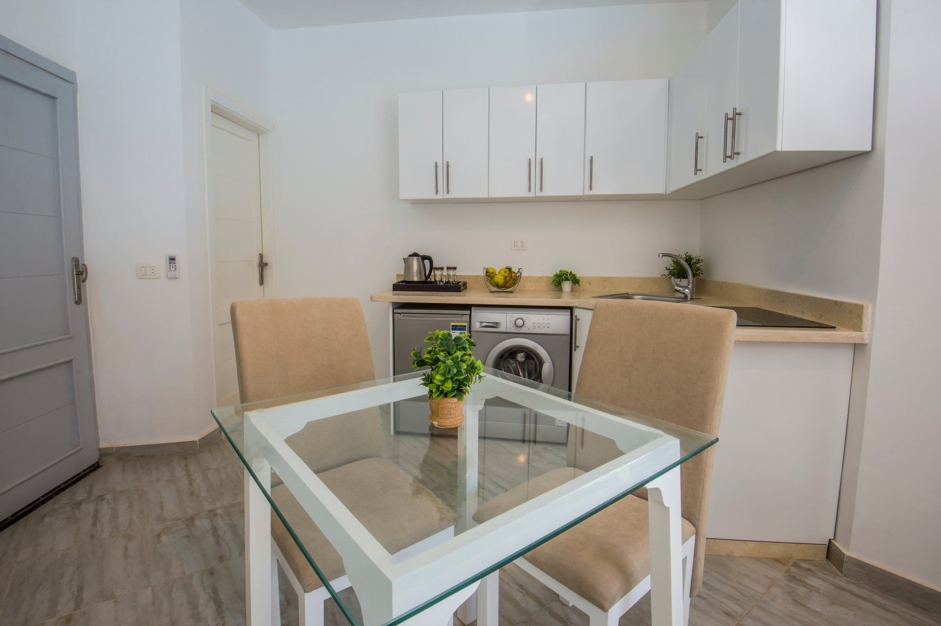 Interior design decor showing modern kitchen and appliances in luxury apartment showroom with dining table