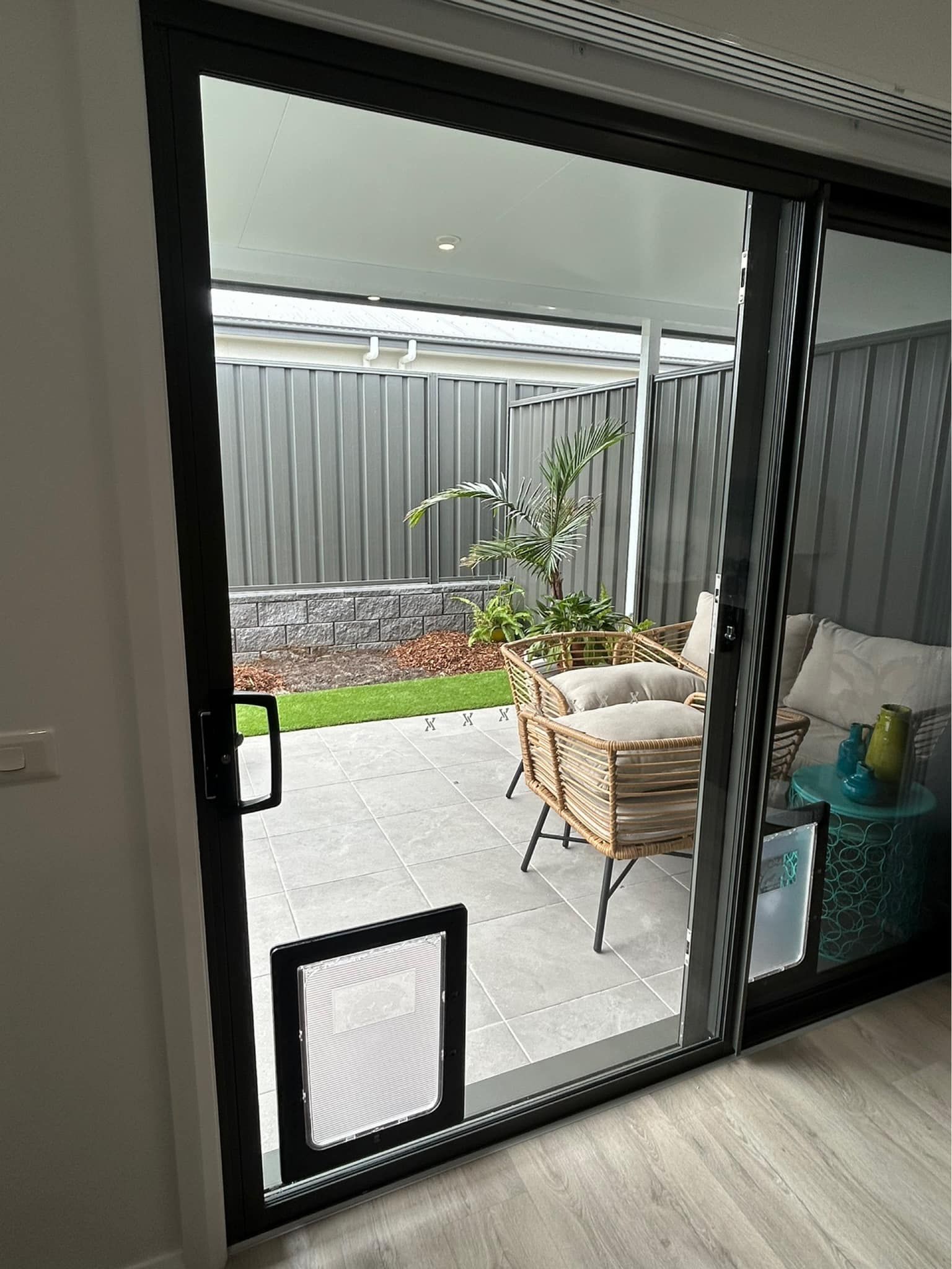 Sliding door with a pet door — Cessnock Glass in Cessnock, NSW