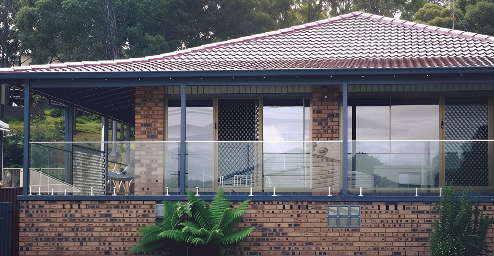 A Brick House With a Balcony and a Tiled Roof — Cessnock Glass in Cessnock, NSW