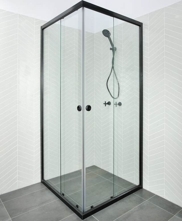 A shower with a glass screen with a black outside and white tiles in the background — Cessnock Glass in Central Coast, NSW