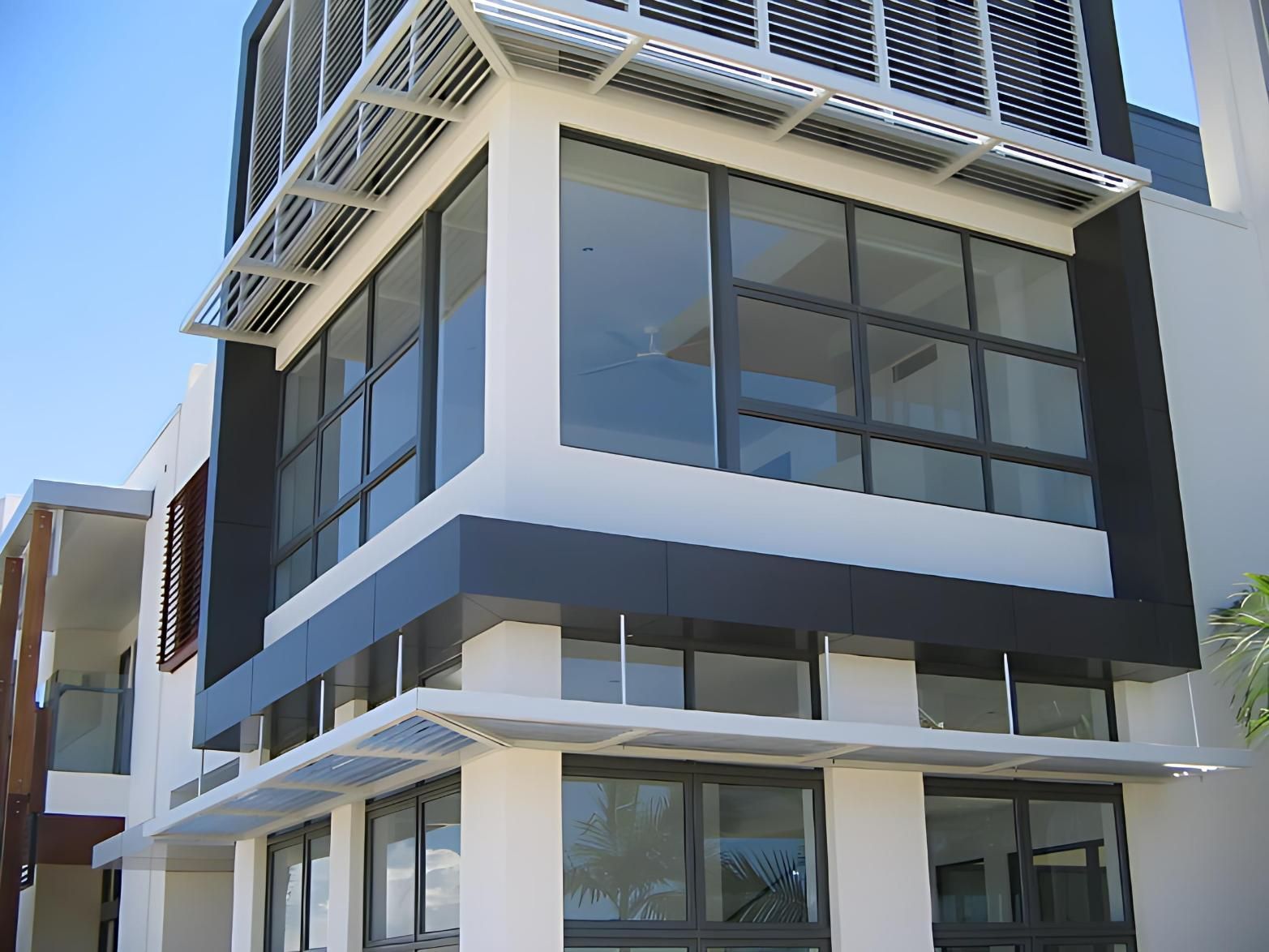 A Building With a Lot of Windows and a Canopy on Top — Cessnock Glass in Cessnock, NSW