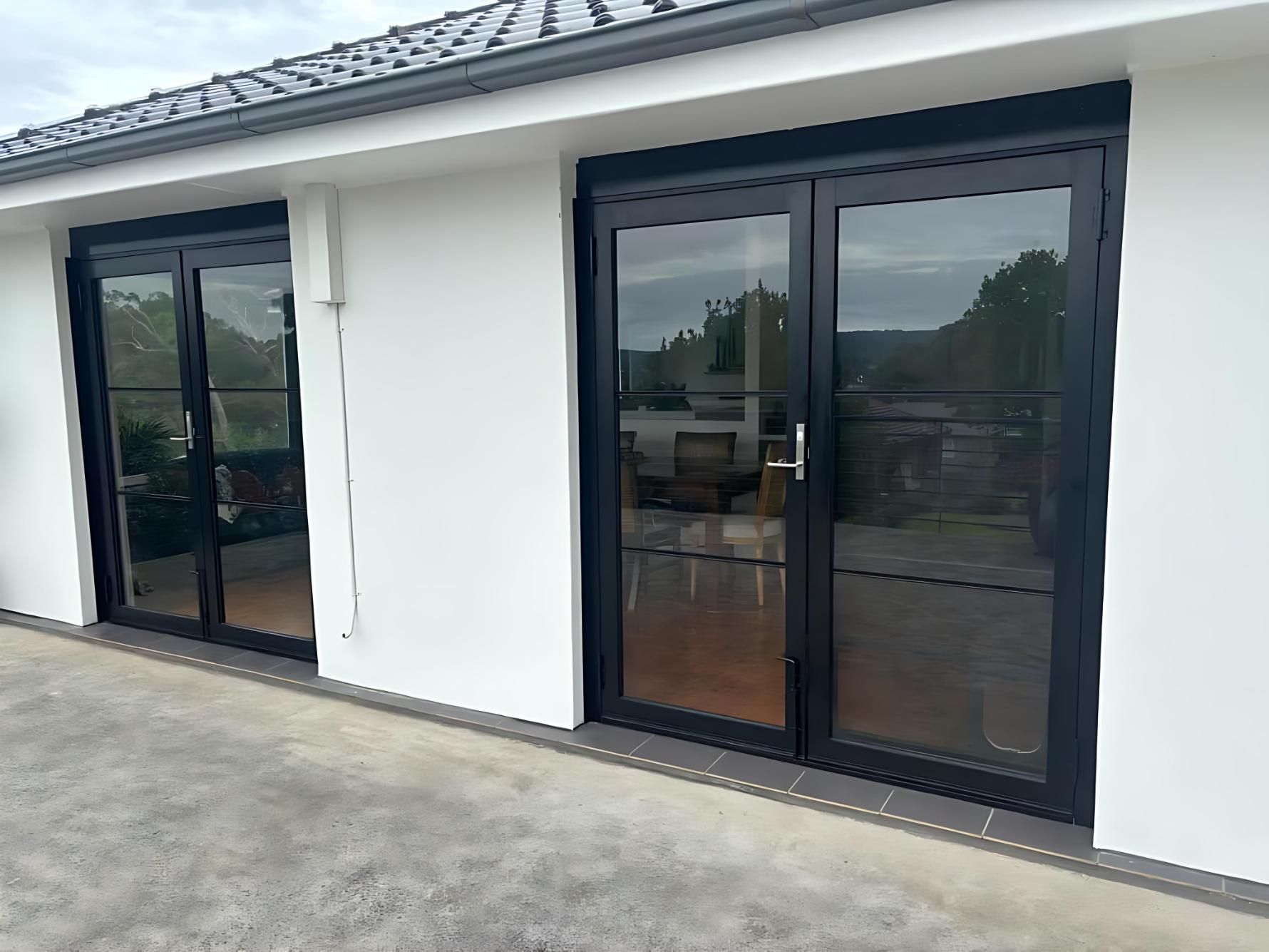 A White House With Black Sliding Glass Doors — Cessnock Glass in Lake Macquarie, NSW