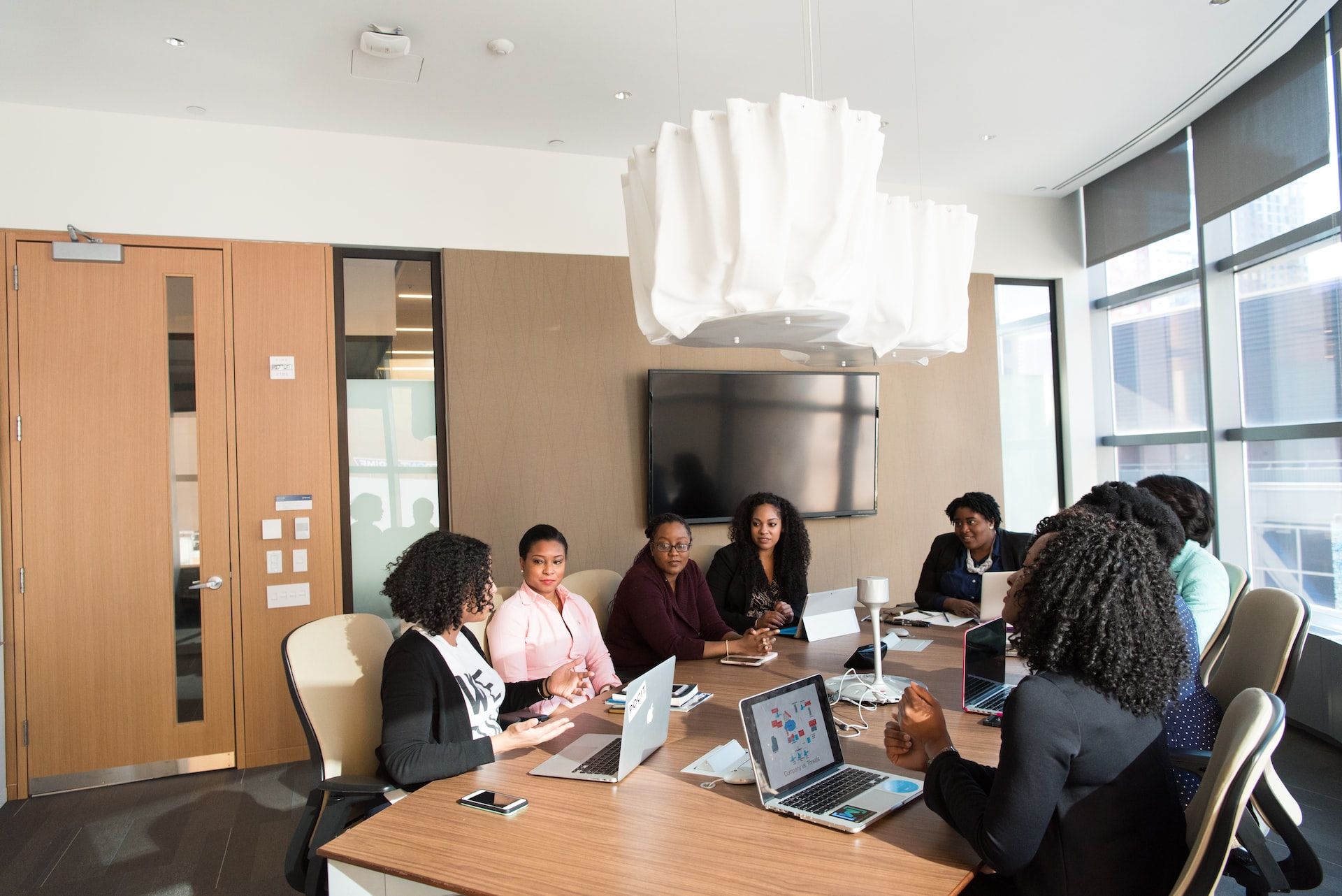 Image of a business meeting with digital devices that all store data
