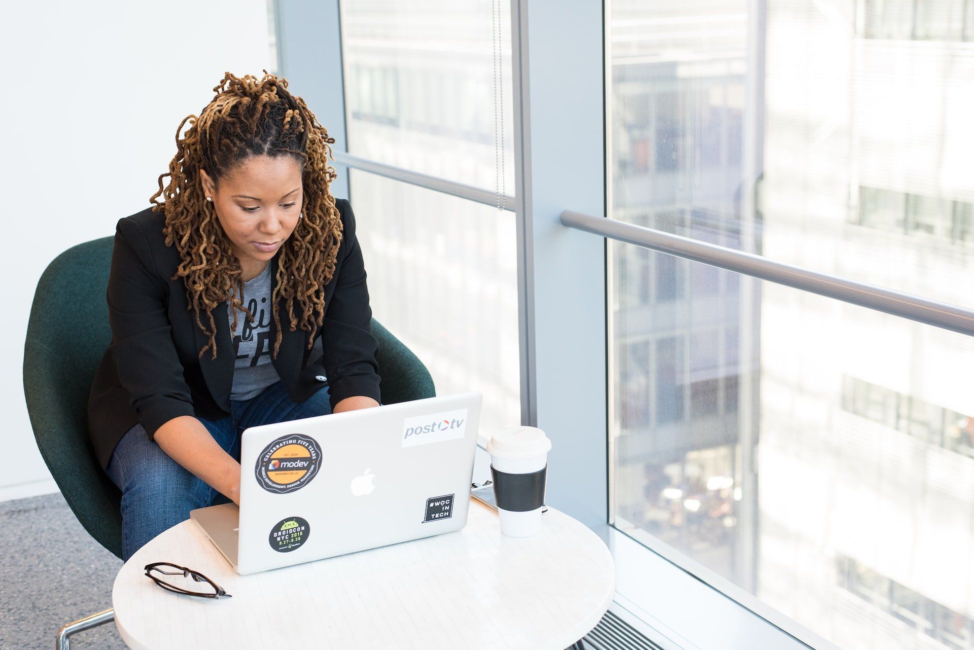Image of a woman working at a laptop, looking productive