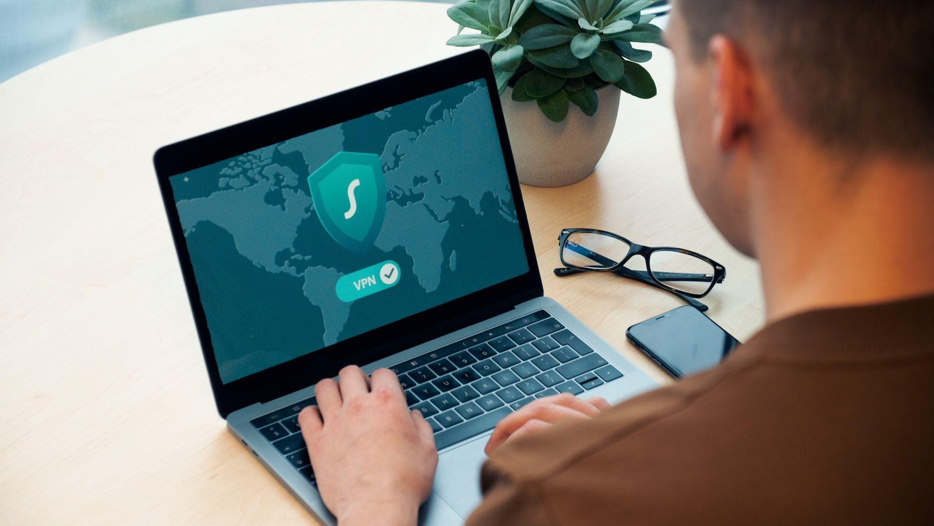 Image of a person using a VPN on their laptop for cybersecurity