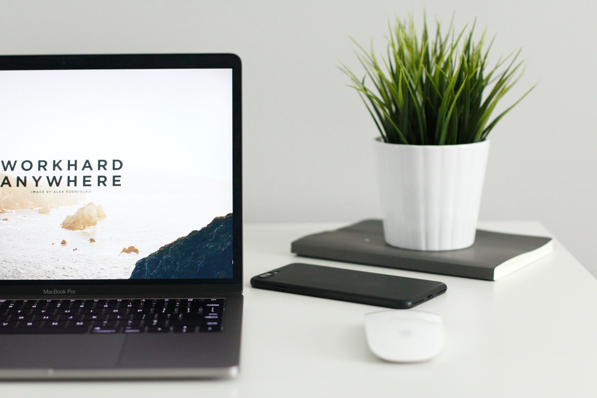 Image of a laptop that says work hard anywhere, showing the benefits and challenges of remote work