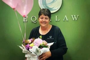 Woman Holding A Flowers — Equilaw Solicitors In Muswellbrook NSW