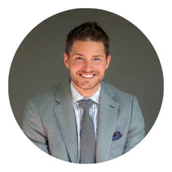 A man in a suit and tie is smiling in a circle