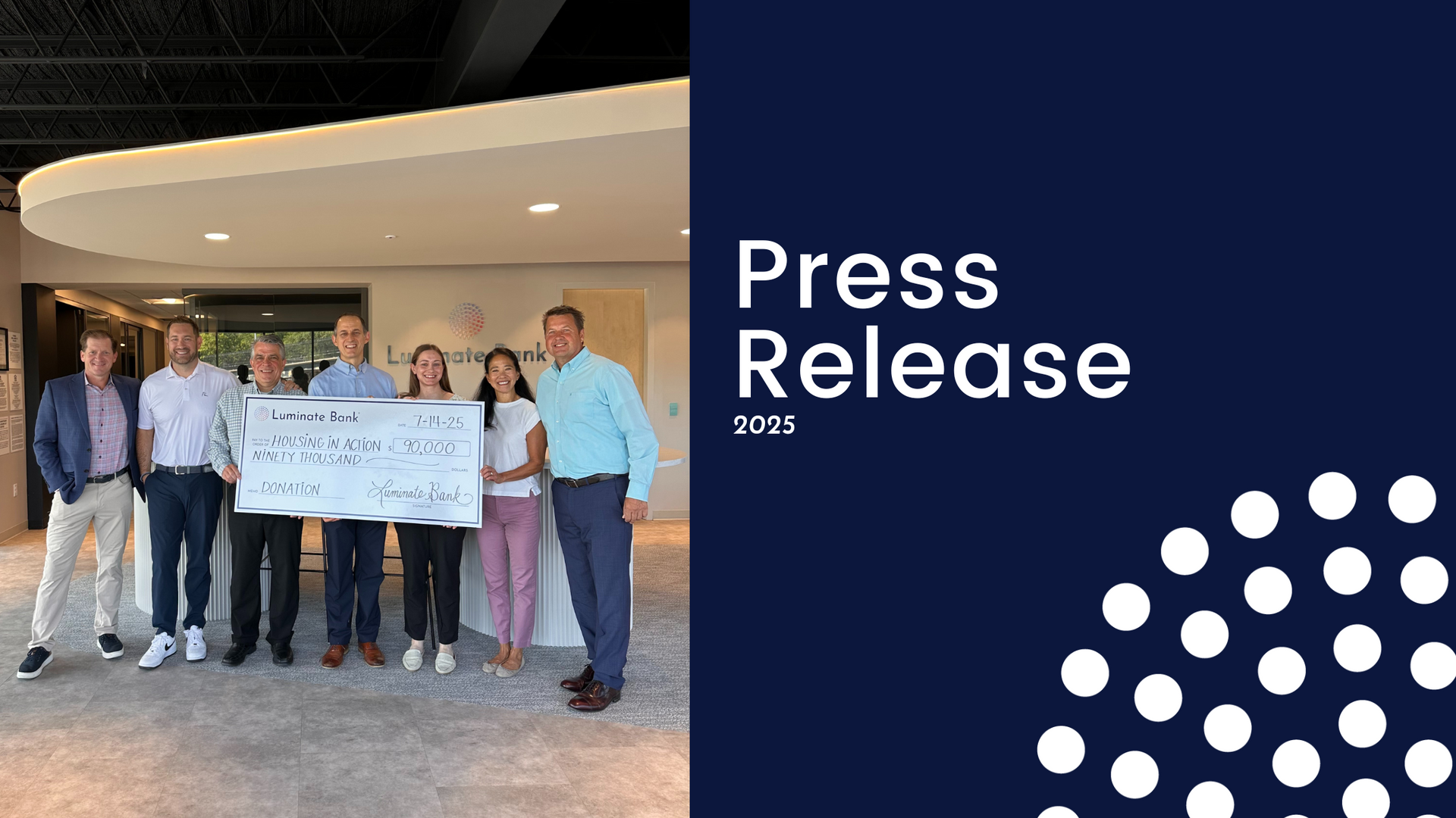 Group of people holding a large check indoors. A