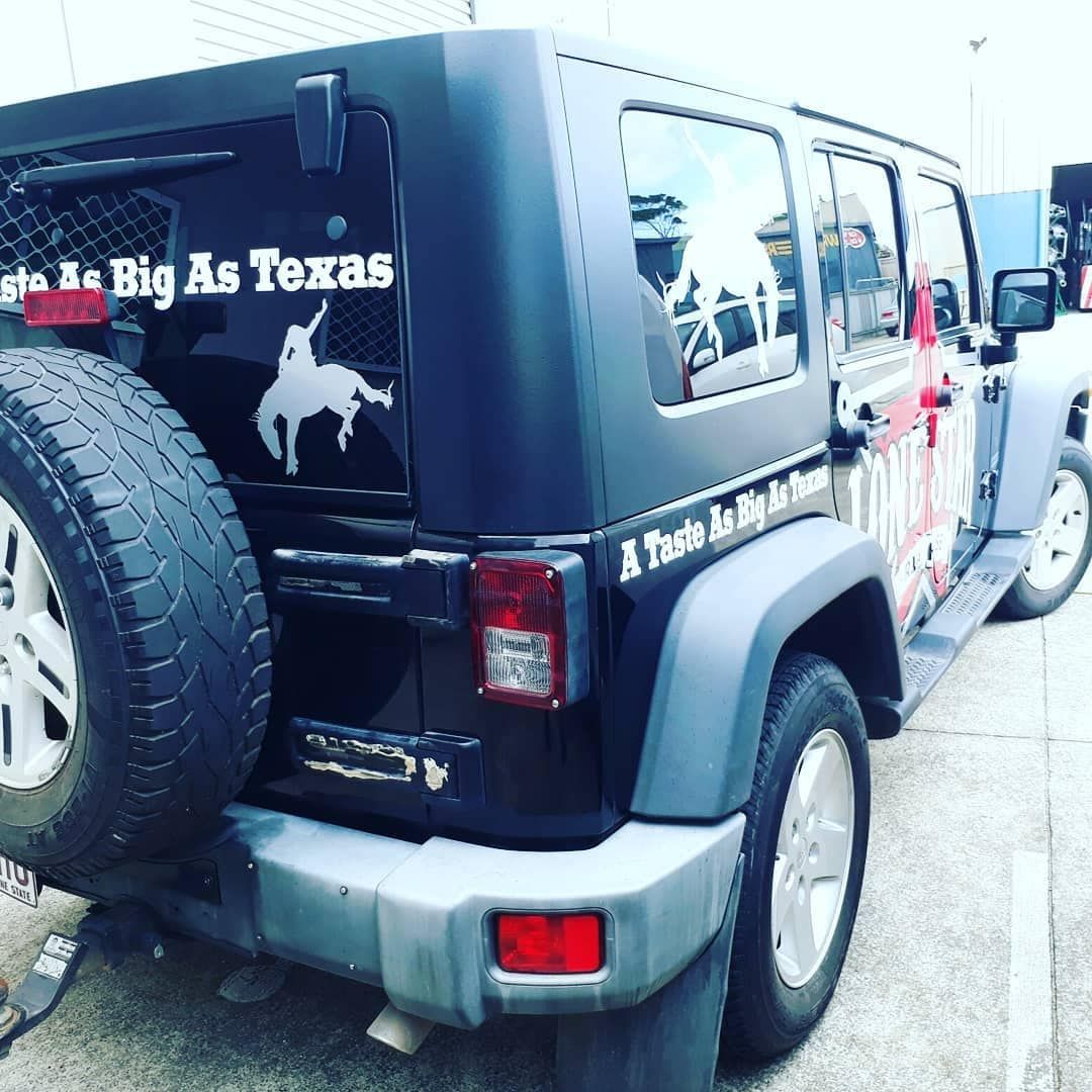 A Black Jeep with A Sticker on The Back — DNA Signs in Tweed Heads, NSW